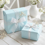 Light blue wrapping paper on gifts with white lace ribbon, for baby shower, wedding, or elegant birthday.