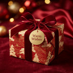Luxury red and gold Christmas wrapping paper with a red velvet bow and gift tag by Wrapped Studios.