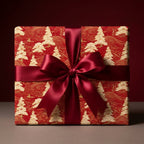Luxury red and gold Christmas wrapping paper with holiday tree pattern and burgundy bow by Wrapped Studios.
