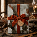 Rustic vintage wrapping paper with a burnt orange velvet bow by Wrapped Studios.