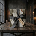 Rustic birthday wrapping paper with frayed grey ribbon on wooden table. Luxury gift wrap by Wrapped Studios.