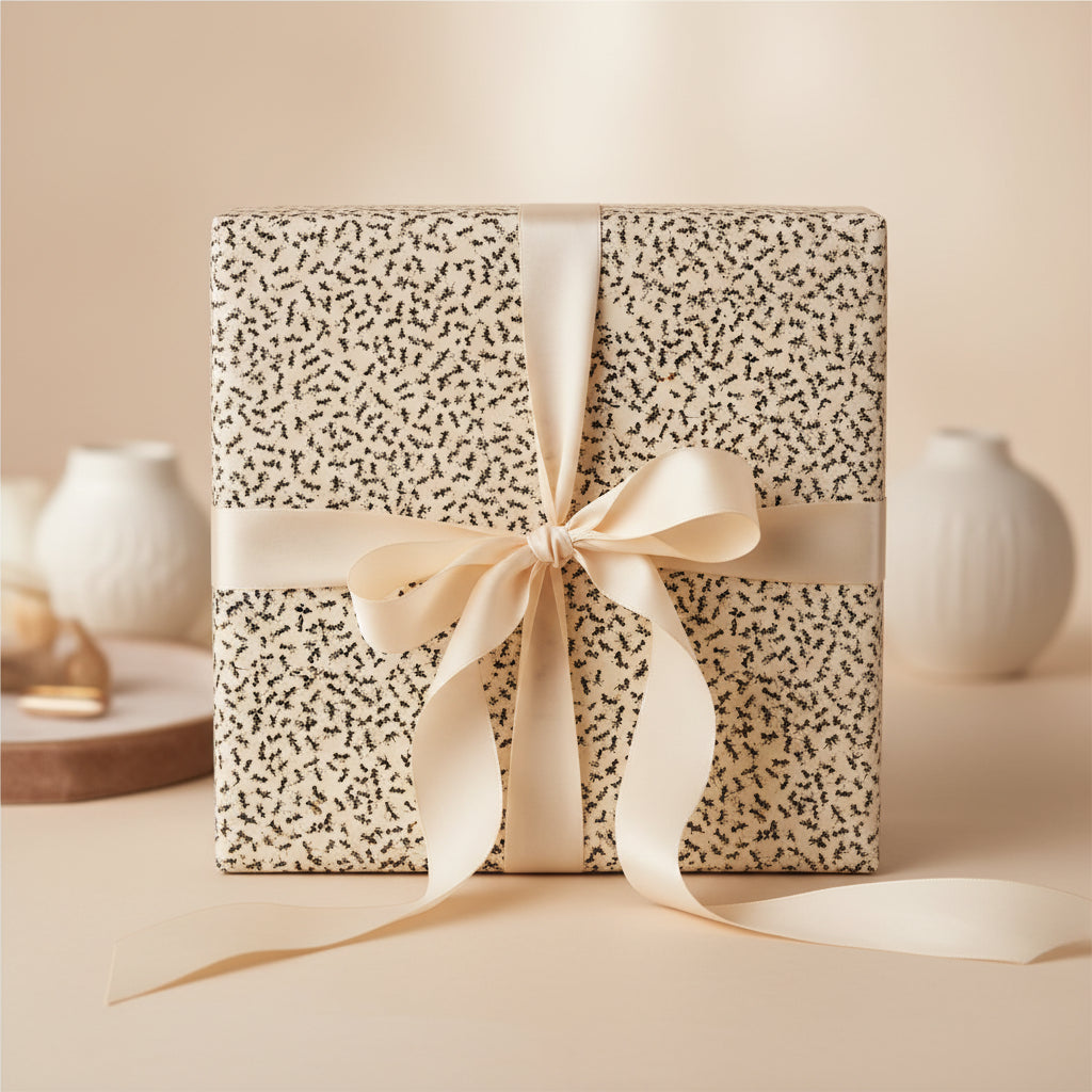 Elegant gift wrapped in botanical print wrapping paper with a satin ribbon bow.