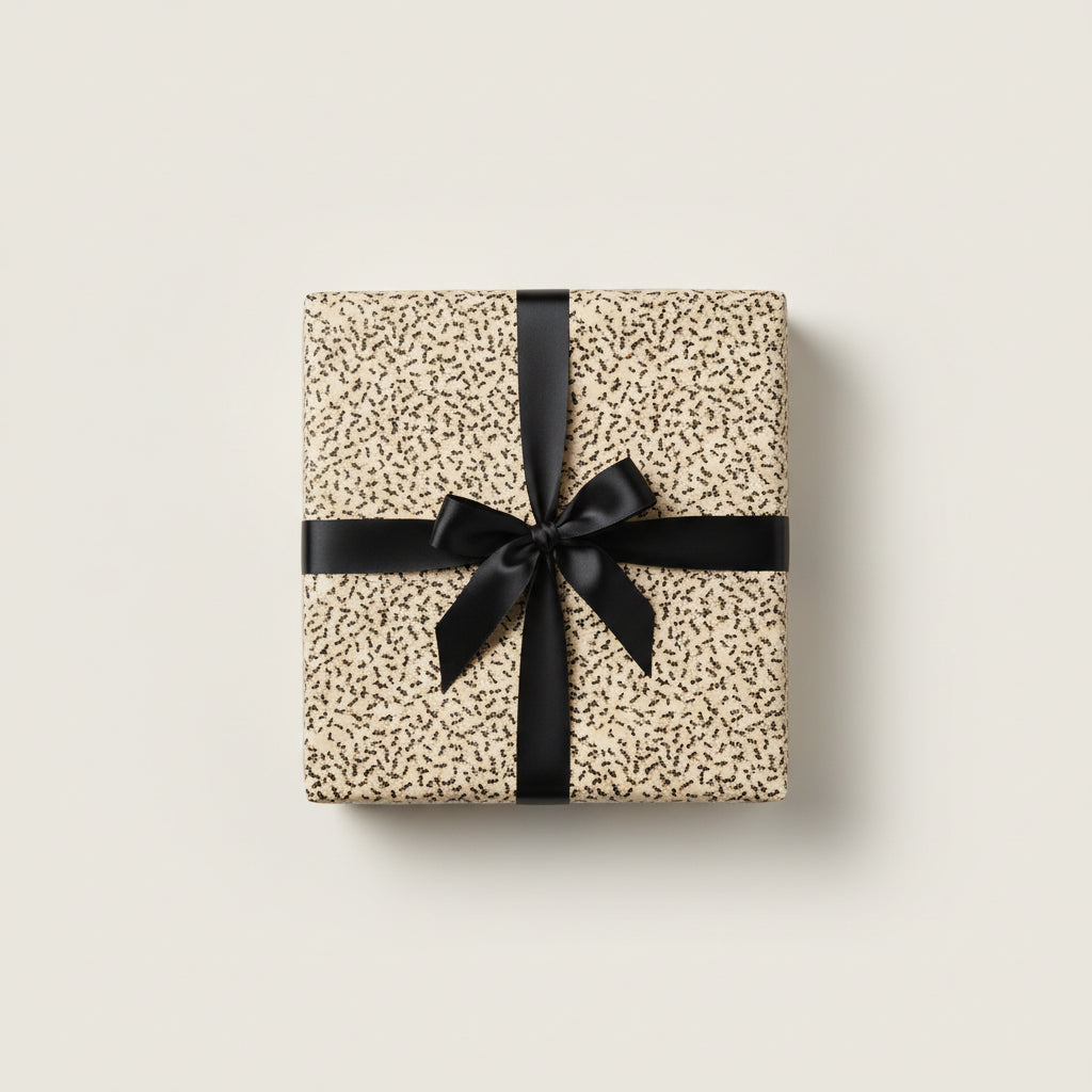 Beige luxury gift wrap with minimalist black pattern and satin bow for birthday or special occasion.