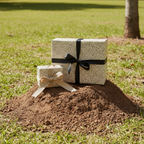 Modern gift boxes wrapped in patterned paper with black and tan ribbon outdoors.