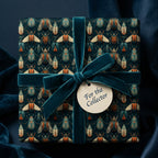 "For the Collector" gift wrapped in beetle-patterned paper with teal velvet ribbon.