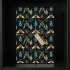 Stylish gift wrapped in unique beetle-patterned wrapping paper with twine and a tag.
