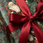 Vintage Santa Christmas wrapping paper tied with a luxury red satin ribbon by Wrapped Studios.