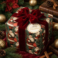 Luxury vintage Santa Claus wrapping paper with a red velvet bow and Christmas tag by Wrapped Studios.