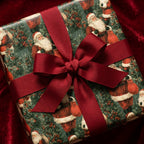 Vintage Santa wrapping paper with a red grosgrain bow on a Christmas gift box by Wrapped Studios.