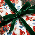 Vintage Santa Claus holiday gift wrap tied with a green velvet ribbon bow by Wrapped Studios.
