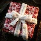 Pink rose floral wrapping paper with elegant white faux fur ribbon for luxury gifts. Wrapped Studios.