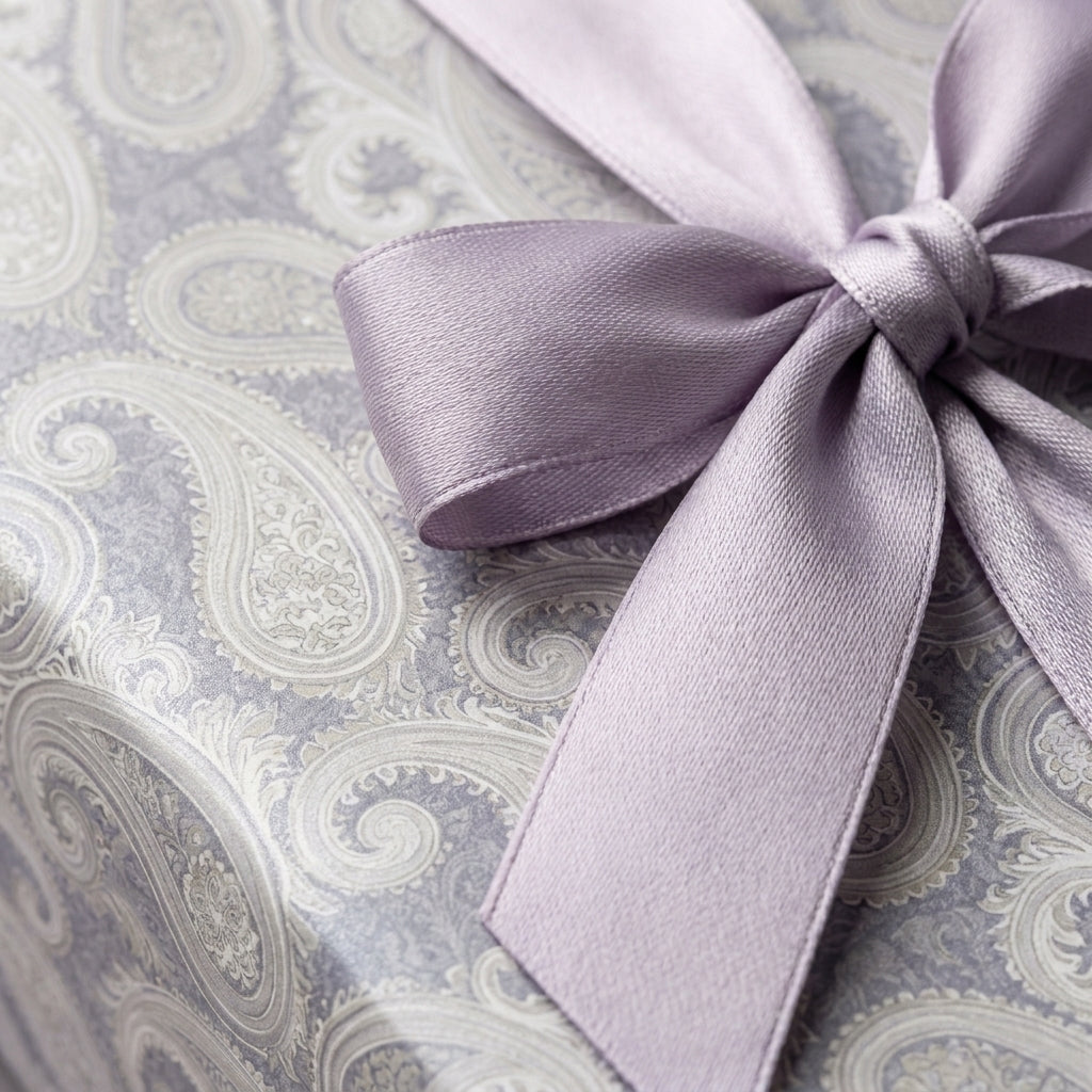 Luxury lavender paisley wrapping paper with a satin ribbon bow by Wrapped Studios.