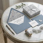 Elegant blue paisley wedding wrapping paper and luxury gift box on marble table by Wrapped Studios.