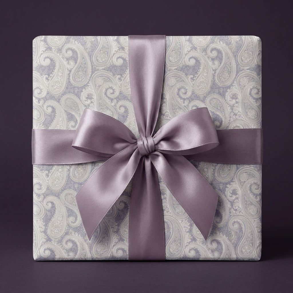 Elegant purple paisley wrapping paper with a luxury satin bow by Wrapped Studios.