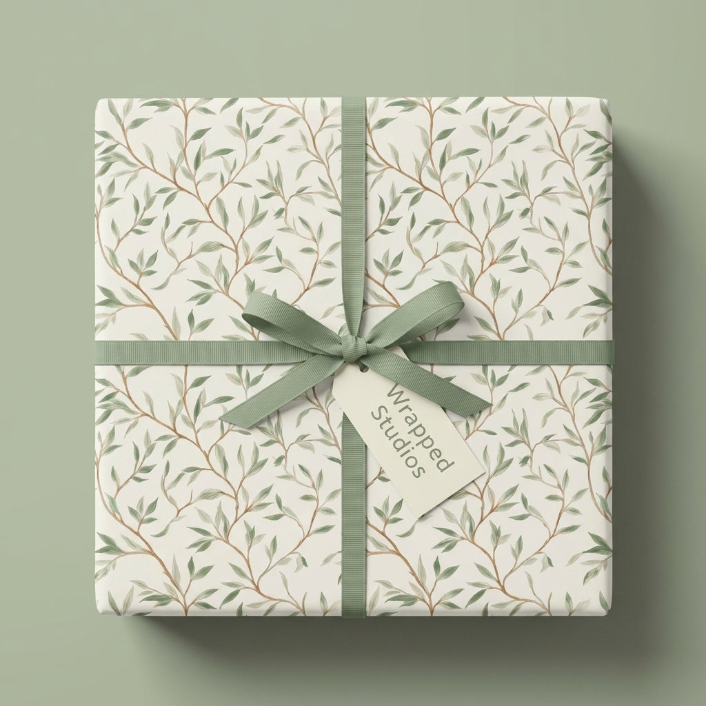 Botanical sage green wrapping paper with a leaf pattern on a gift box with ribbon by Wrapped Studios.