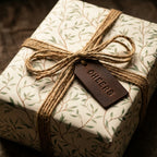 Rustic botanical wrapping paper with twine bow and leather tag from Wrapped Studios.