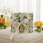 Square gift box in lemon-themed wrapping paper with rustic linen ribbon, elegant summer birthday wrapping paper.