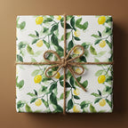 Gift box in lemon print wrapping paper with twine bow, perfect for summer birthdays or citrus themed party.