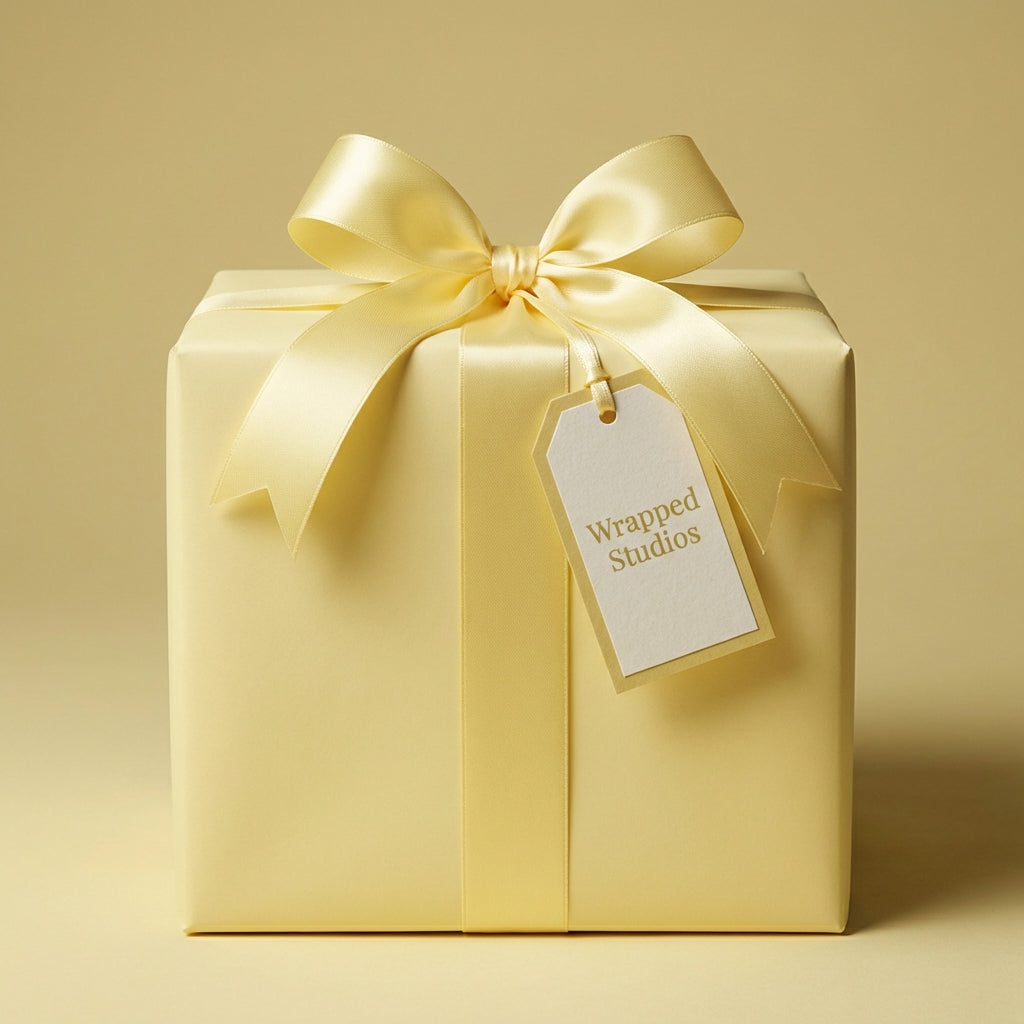 Elegant lemon yellow wrapping paper with satin ribbon bow and gift tag.
