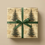 Vintage Christmas tree wrapping paper with a green satin bow on a rustic holiday gift box by Wrapped Studios.