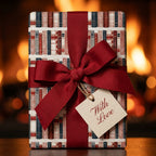 Vintage book wrapping paper with a burgundy ribbon and gift tag by Wrapped Studios.