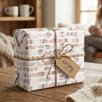 Book wrapping paper with watercolor bookshelves by Wrapped Studios, tied with rustic twine.