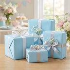 Light blue gift boxes wrapped in solid color wrapping paper with white and silver ribbons, perfect for baby shower presents.