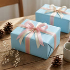 Light blue wrapping paper with pink and cream ribbon, perfect for baby shower or birthday gift wrap.