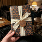 Luxury vintage wrapping paper in navy and gold with a cream ribbon bow by Wrapped Studios.