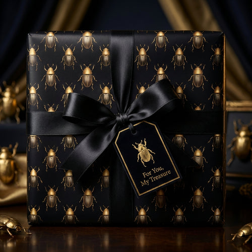 Elegant black gift wrapped in beetle-print paper with a black satin bow and "For You, My Treasure" gift tag.