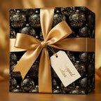 Elegant Christmas gift wrap with gold ribbon and ornate black ornament pattern.