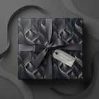 Elegant gift box wrapped in black & silver floral wrapping paper with gray satin ribbon bow.