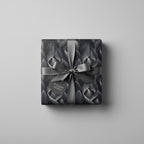 Elegant gray gift wrap with a leaf pattern and satin bow, perfect for luxury gift giving.
