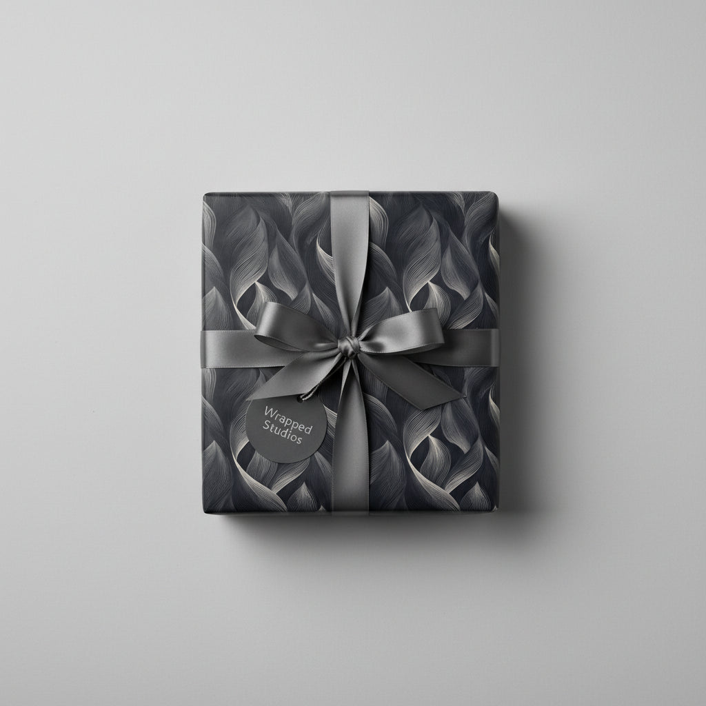 Elegant gray gift wrap with a leaf pattern and satin bow, perfect for luxury gift giving.