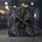 Elegant gift wrapped in luxury gray wrapping paper with a wavy pattern and matching ribbon.