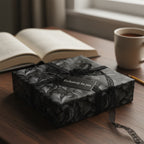 Elegant black floral wrapping paper with lace ribbon on gift box; tag reads "Exclusively for you."