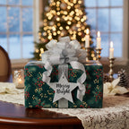 Christmas gift wrapped in dark green floral wrapping paper with silver bow and "Merry & Bright" tag.