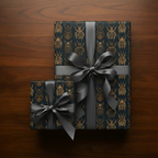 Two gifts wrapped in luxury gift wrap with a gold beetle pattern and gray satin ribbons.