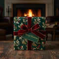 Elegant Christmas gift wrapped in green floral paper with red velvet ribbon, on a wood table by a fireplace.