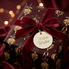 Elegant Christmas gift wrap with burgundy velvet ribbon and "Warm Wishes" tag from Wrapped Studios.