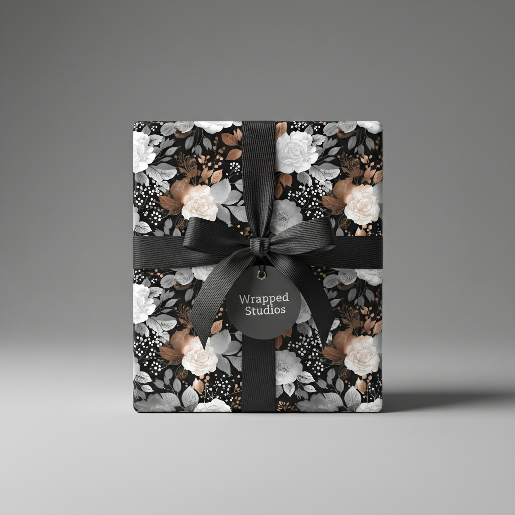 Elegant gift wrapped in dark floral wrapping paper with a satin black ribbon and bow.