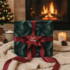Cozy Christmas scene with a gift wrapped in elegant, dark green patterned wrapping paper and tied with a red ribbon.