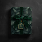 Elegant gift wrapped in dark green botanical print paper with velvet ribbon and "A Special Gift" tag.