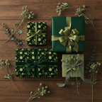 Elegant floral wrapping paper in shades of green, tied with ribbon, for birthday or Christmas gifts.