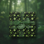 Elegant gift box wrapped in green floral wrapping paper with sheer ribbon bow for nature lovers.