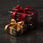 Two gifts wrapped in black wrapping paper with red and gold dots and coordinating ribbons.