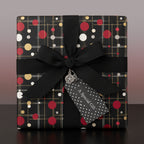 Elegant gift wrapped in black paper with a red, gold, and white dot pattern, tied with a black ribbon and "A Special Gift" tag.