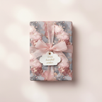 Luxury marble wrapping paper in blush pink and gray, tied with a sheer pink ribbon and "With heartfelt wishes" gift tag.