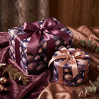 Elegant Christmas gift wrap featuring gold ornament pattern and satin ribbon bows.