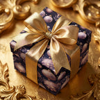 Elegant Christmas gift wrap: Navy box with gold ribbon and ornament pattern on a gold surface.